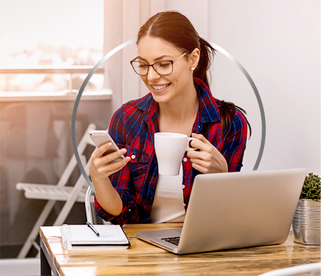 Smiling young woman wearing glasses on her phone happy after Canesten thrush treatment